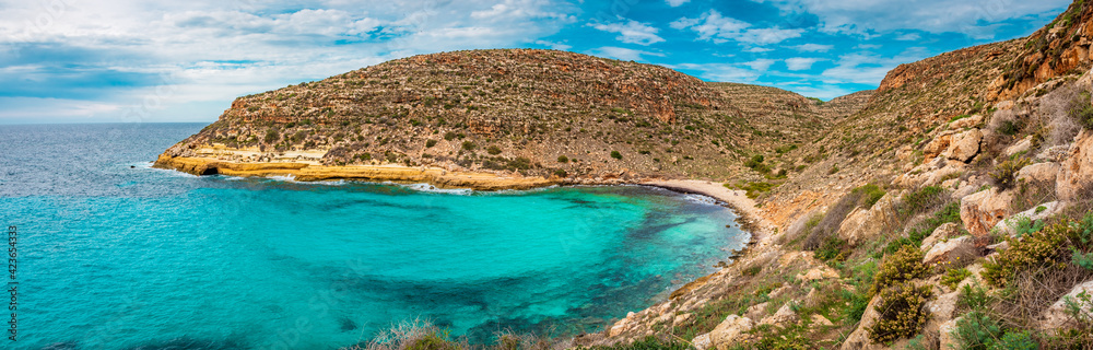 Panoramic view of Cala Pulcino, a pristine beach on the remote island of Lampedusa,  Italy