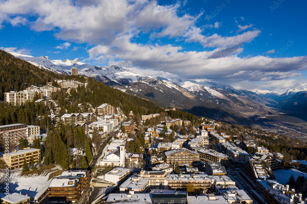 Aerial view of the Crans-Montana village in the Swiss alps in Canton Valais in Switzerland. The village is a famous tourism and ski resort destination