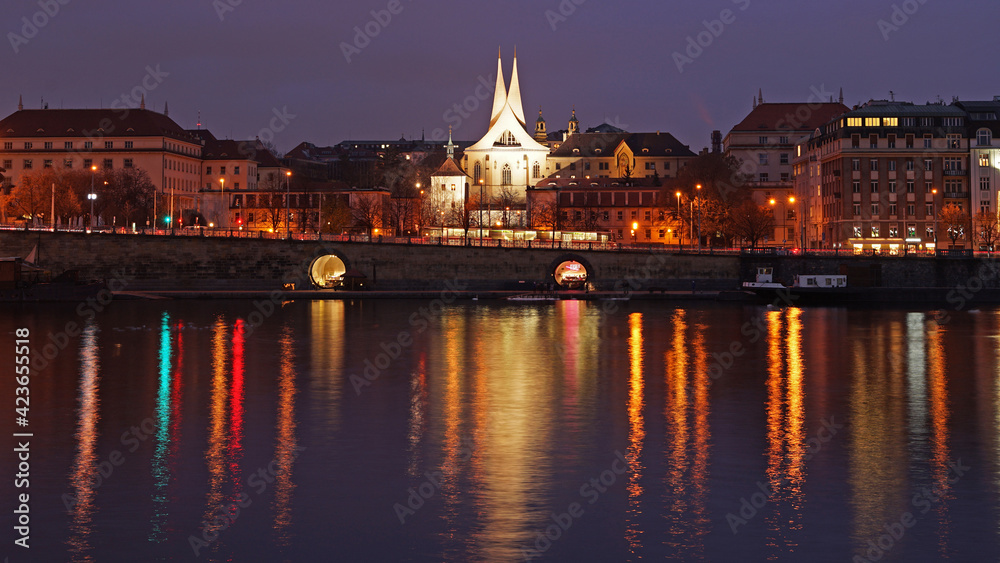 Naplavka vibrant river bank with bars and restaurants in Prague, night view with colourful lights,