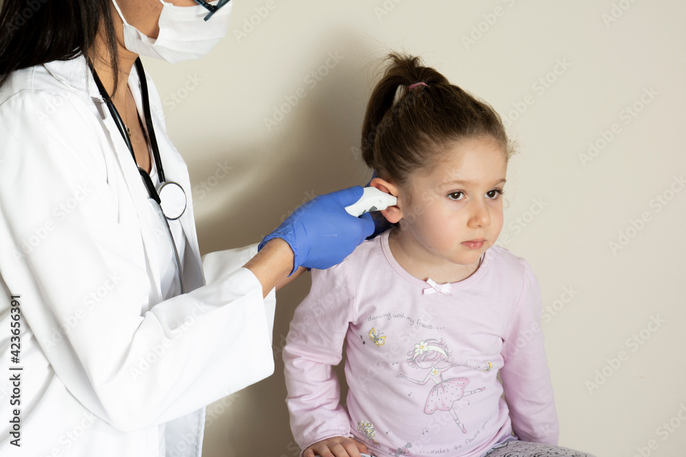chubby little girl in pediatric examination by her doctor. ENT ( Ear, Nose, Throat ) Examination. Selective Focus chubby little girl in pediatric examination by her doctor. ENT ( Ear, Nose, Throat ) Examination. Selective Focus