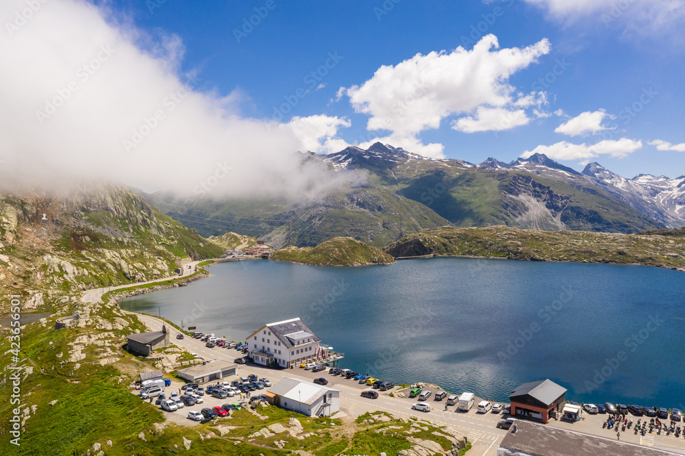 Aerial view of the lake and restaurant at the summiit of the Grimsel pass in the alps between the Cantons of Bern and Valais in Switzerland