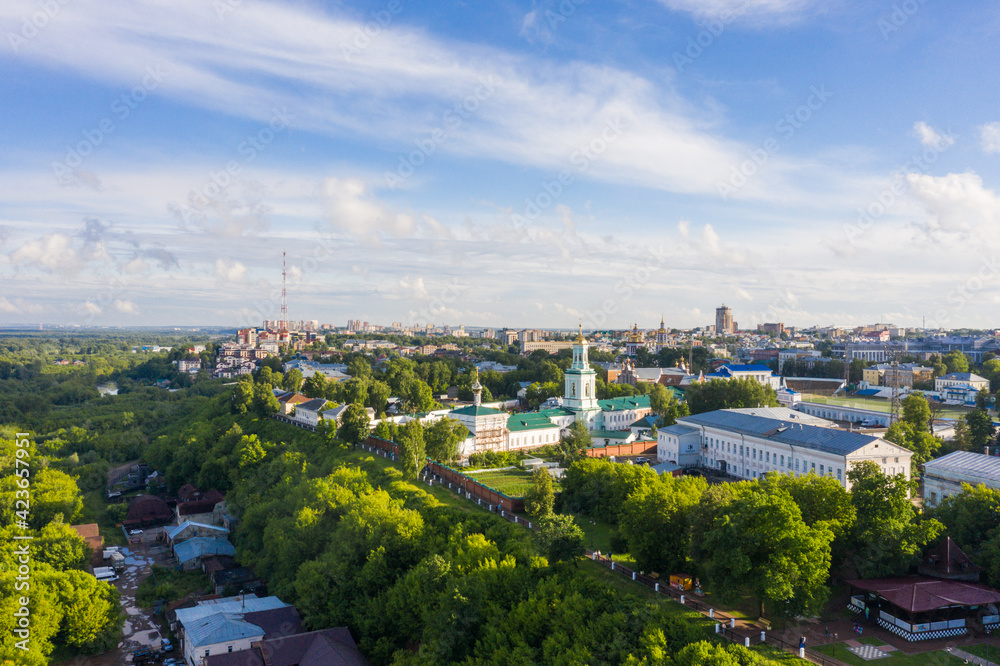 Kirov and the high bank of the river Vyatka and the Alexander Grin Embankment and Trifonov Monastery on a sunny summer day.