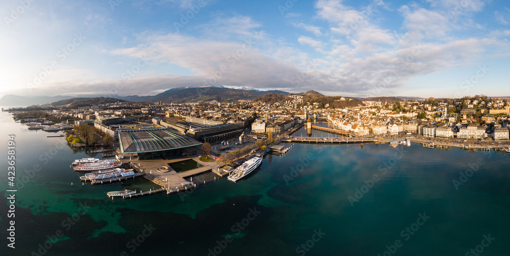 Aerial view of the Lucerne lakefront with theater, the train station and cruise ship and the old town in the background in Switzerland