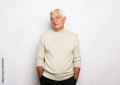 Old people, emotion and modern lifestyle concept. Senior smiling man with gray hair wearing casual over white background.
