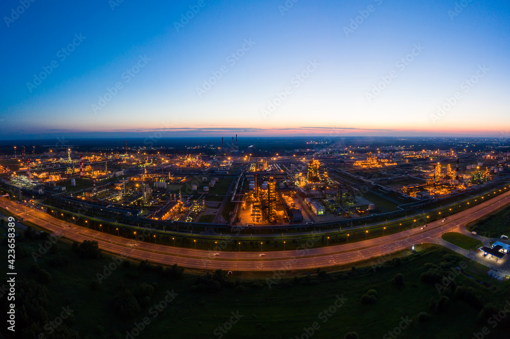 Oil refinery plant industry, Refinery factory. oil storage tank, rectification column and pipeline against the backdrop of sunset in summer, Russia