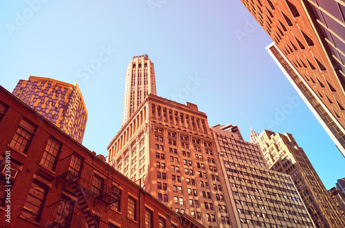 Looking up at Manhattan buildings, color toned picture, New York City, USA.