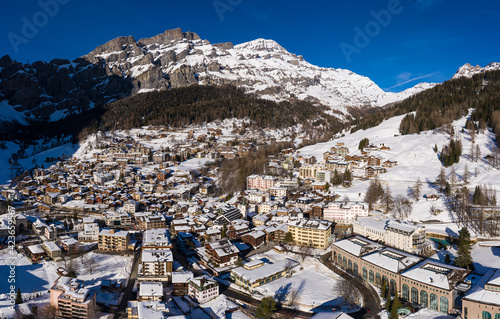 Aerial view of the Leukerbad, or Loeche les bains in French, village in the alps in Canton Valais in Switzerland on a sunny winter day.