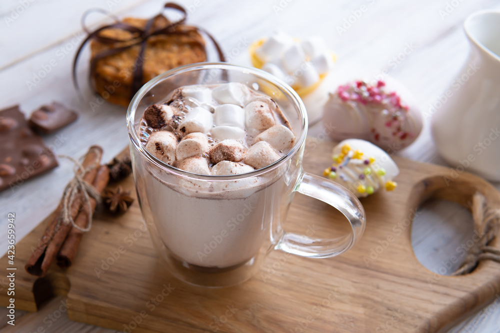 A mug of marshmallow drink on the table by the window. A mug of marshmallow drink on the table by the window.