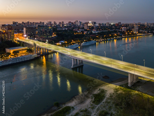 Rostov-on-Don, Russia - July 06, 2020: Voroshilovsky bridge at sunset and view of the left bank of the Don river, Rostov-Arena stadium with text Russia