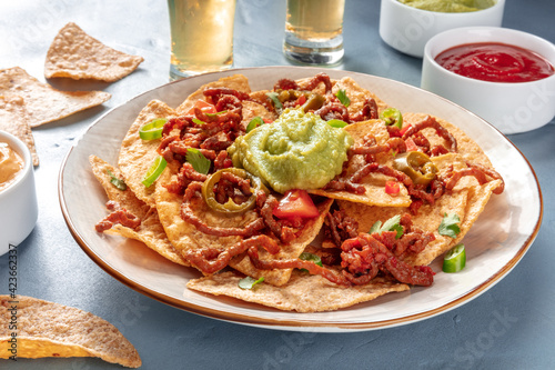 Nachos with beef and gucacamole, with tequila