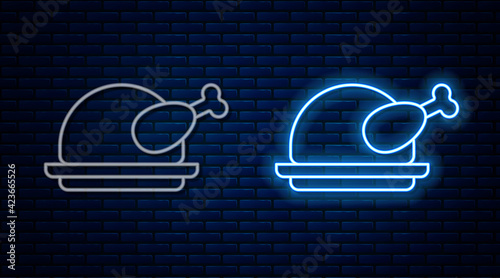 Glowing neon line Roasted turkey or chicken icon isolated on brick wall background. Vector