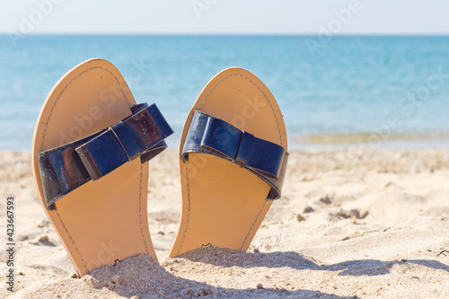 women's sandals on a sandy beach