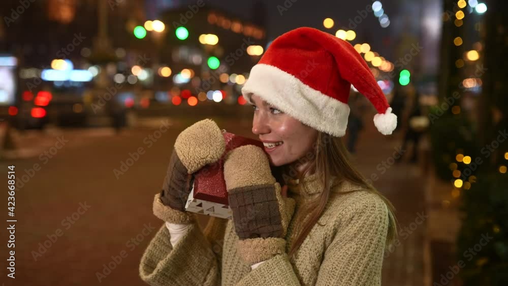 Young woman giving box for you outdoor. Gift exchange concept. Young woman giving box for you outdoor. Gift exchange concept.
