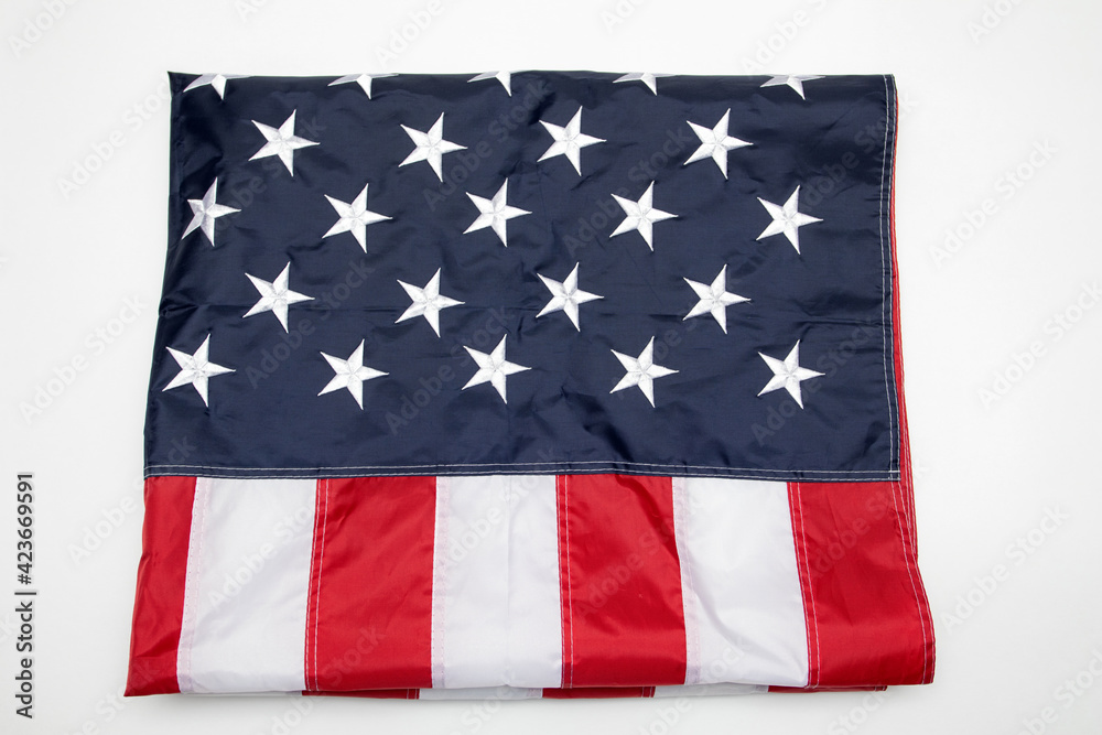 Obraz premium USA flag folded on white background. American flag folded on white background. Memorial day concept.