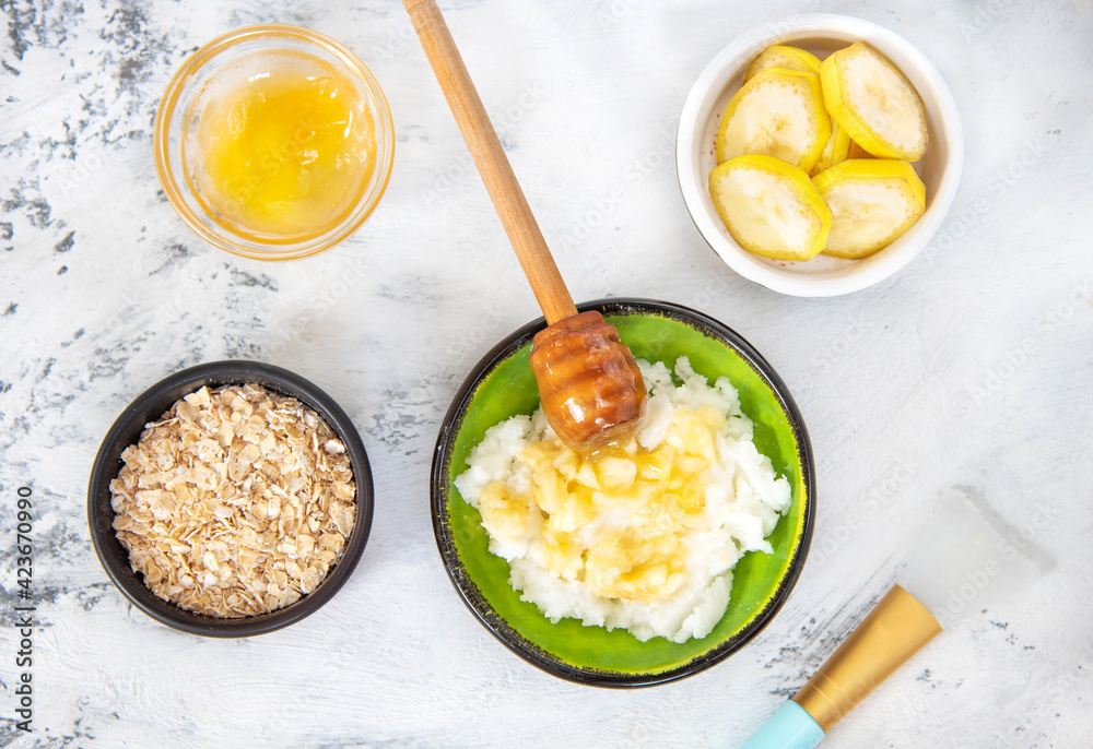 Ingredients for homemade scrub banana, honey, oatmeal coconut oil. Beauty Concept Ingredients for homemade scrub banana, honey, oatmeal coconut oil. Beauty Concept