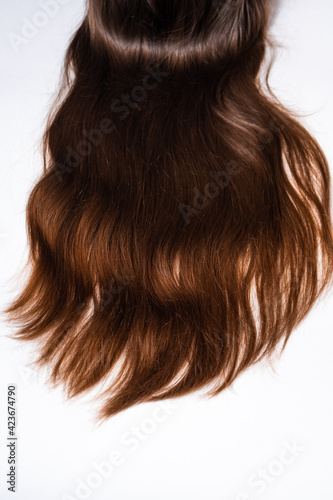 Bright brown hair on a white background close-up