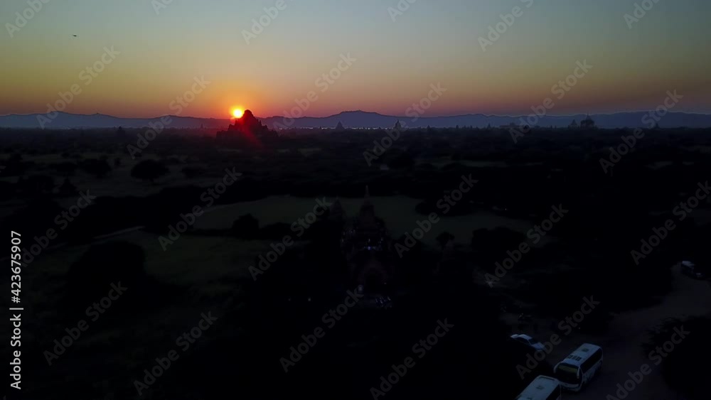 Golden Sky Behind Buddhist Stupa in Wilderness, Bagan, Myanmar, Aerial Rising Golden Sky Behind Buddhist Stupa in Wilderness, Bagan, Myanmar, Aerial Rising
