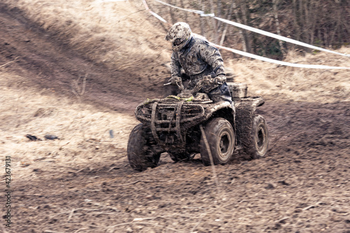 Quad competition. Dirty quad starting in a extreme competition. Dynamic shot of racer on quad motorbike in the race