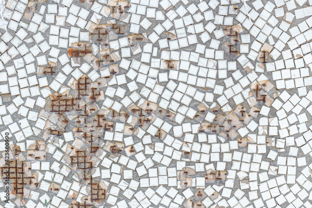 Old white mosaic wall with hole and rust, background from old mosaic.