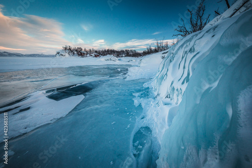 The frozen lake Torneträsk in Swedish Lapland. Beautiful ice forms create an amazing sight. photo