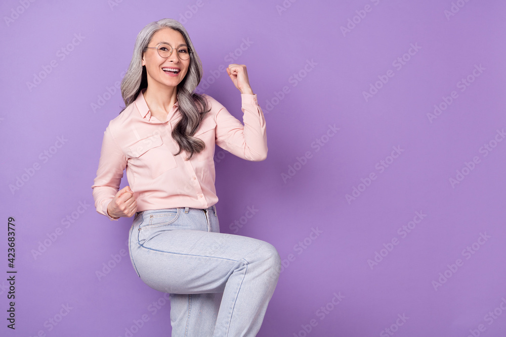 Portrait of attractive lucky cheerful woman specialist rejoicing having fun copy space isolated over violet purple color background