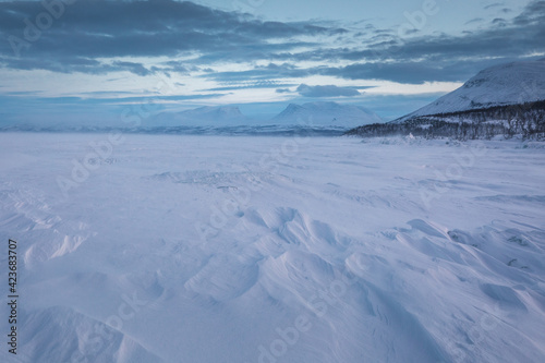 The frozen lake Torneträsk in Swedish Lapland. Beautiful ice forms create an amazing sight.