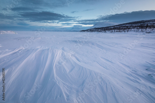 The frozen lake Tornetr  sk in Swedish Lapland. Beautiful ice forms create an amazing sight.