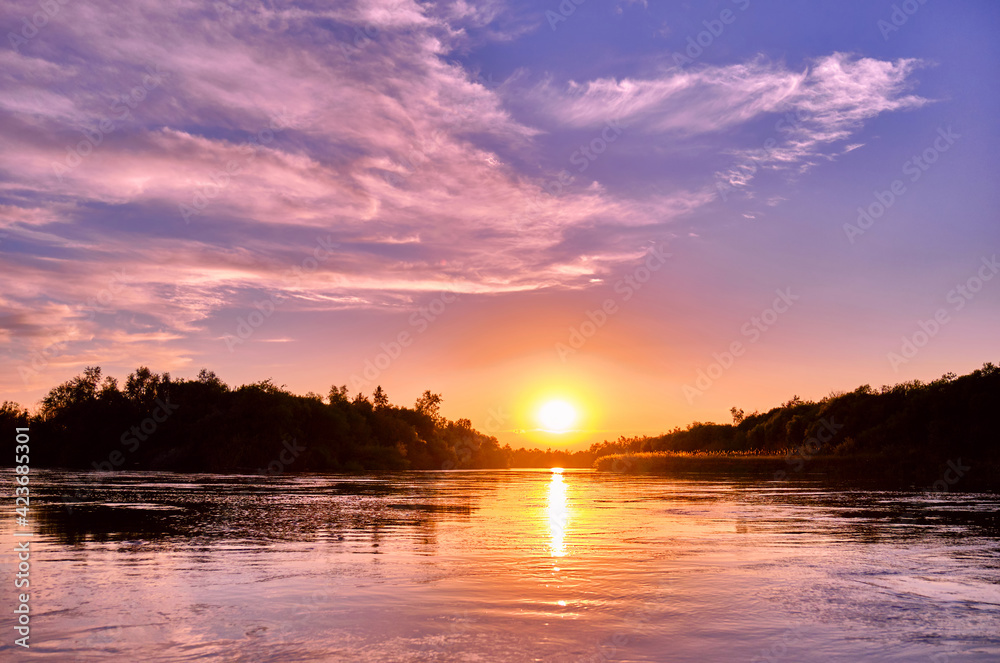 Magic atmosphere of a romantic evening; golden sunset on the river