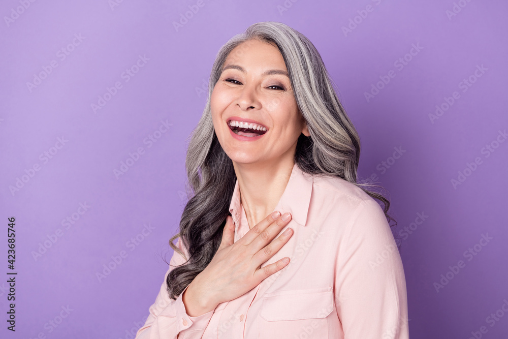 Portrait of attractive cheerful pleased grey-haired woman laughing having fun isolated over violet purple color background Portrait of attractive cheerful pleased grey-haired woman laughing having fun isolated over violet purple color background