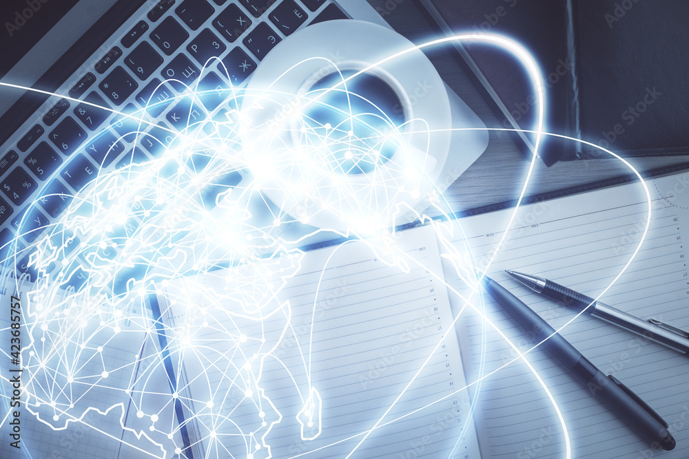 Business theme hologram drawings over computer on the desktop background. Top view. Multi exposure. Concept of international connections. Business theme hologram drawings over computer on the desktop background. Top view. Multi exposure. Concept of international connections.
