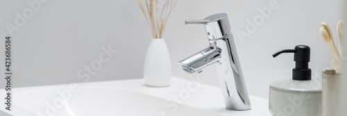Fotografie, Obraz Silver tap in bathroom washbasin, panoramic close-up