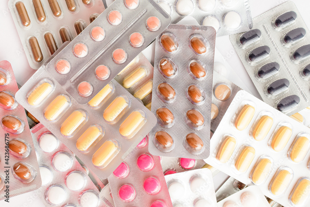 Close up of different medicine pills, tablets and vitamins isolated on white background, pharmaceutical picture taken with soft focus. Close up of different medicine pills, tablets and vitamins isolated on white background, pharmaceutical picture taken with soft focus.