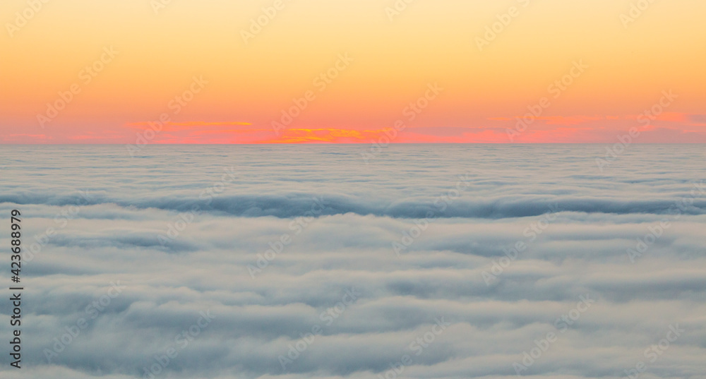 The sunset over a sea of clouds