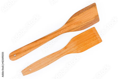 Wooden kitchen spatulas on a white background, top view