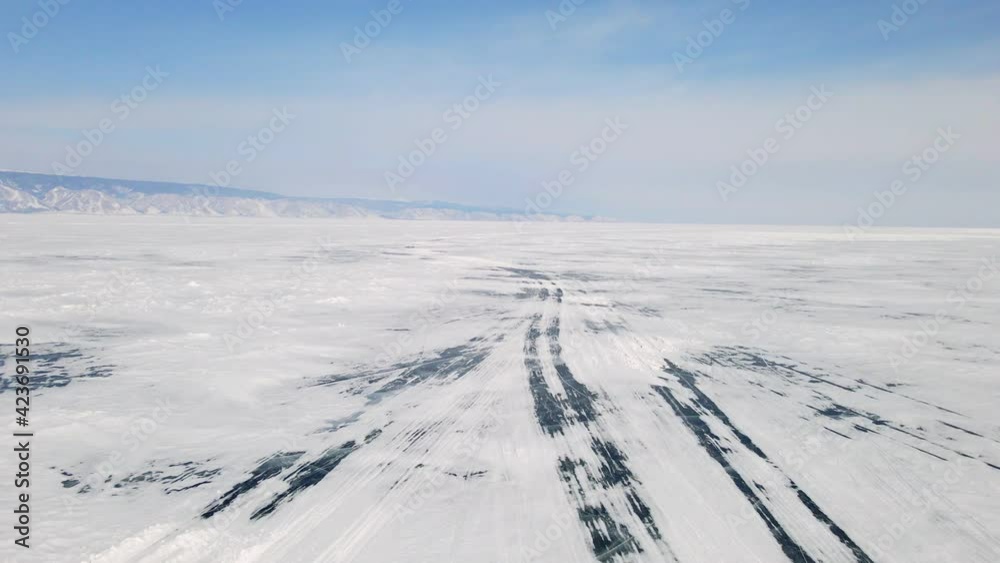 Traces of Car Tire on Ice of Baikal Lake. Car Prints on Snow. Texture of Ice Surface. Aerial View Traces of Car Tire on Ice of Baikal Lake. Car Prints on Snow. Texture of Ice Surface. Aerial View