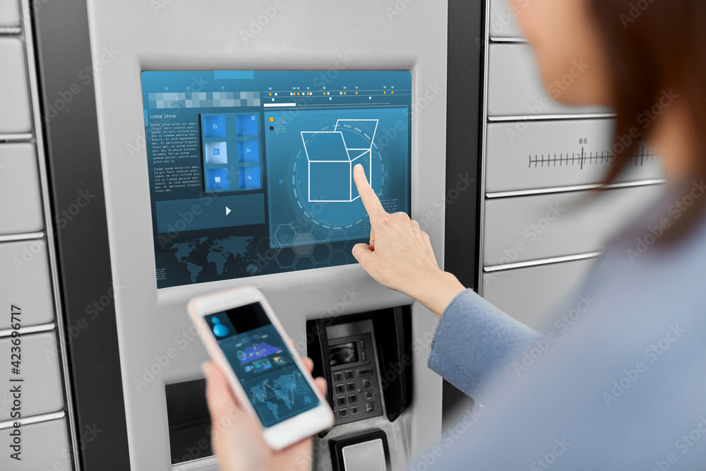 mail delivery, technology and post service concept - close up of woman with smartphone choosing operation on outdoor automated parcel machine's touch screen mail delivery, technology and post service concept - close up of woman with smartphone choosing operation on outdoor automated parcel machine's touch screen