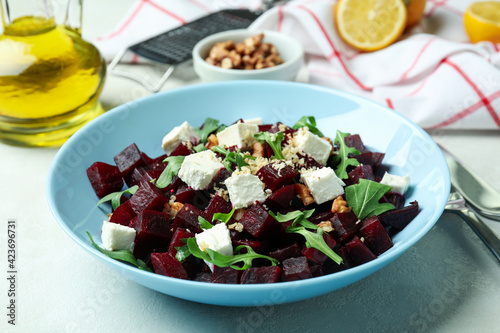 Concept of tasty eating with beet salad on white textured table
