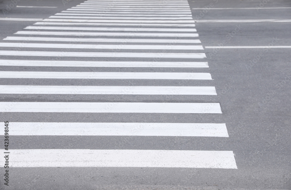White pedestrian crossing on empty city street White pedestrian crossing on empty city street