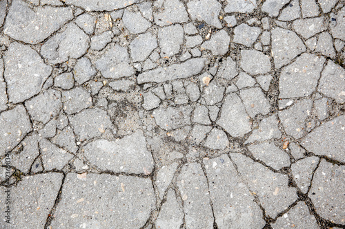The remains of cracked asphalt on the ground. Top view