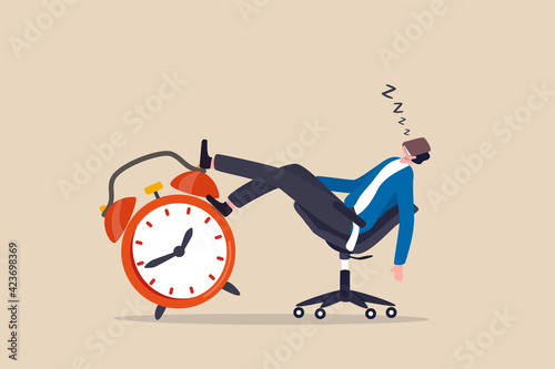 Afternoon slump, laziness and procrastination postpone work to do later, boredom and sleepy work concept, businessman sleeping lay down on office chair and alarm clock covered his face with book. photo