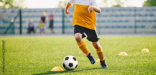 Football Player Running Ball. European Football Training Unit at Sports Club. Teenage Soccer Class. Young Player Improving Dribbling Ball Skills