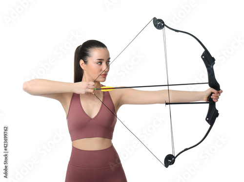 Sporty young woman practicing archery on white background