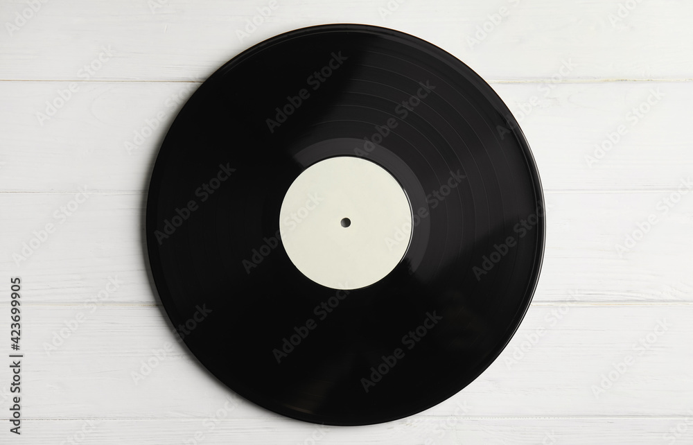 Obraz premium Vintage vinyl record on white wooden table, top view