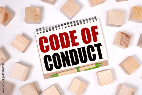 Code Of Conduct. text on notepad on white background. near the wooden cubes Business concepts