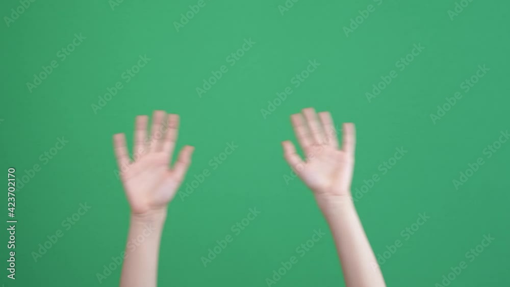 Kid hands waving saying greeting, goodbye making hand gestures on chroma key green screen background