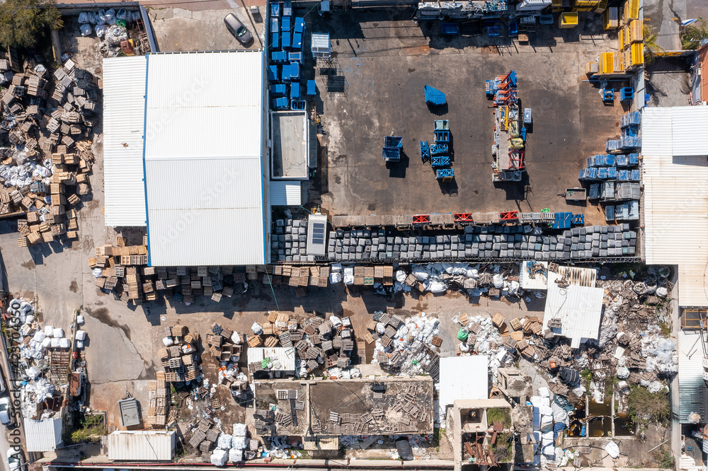 Large scrapyard with piles of sorted metals, Aerial view.