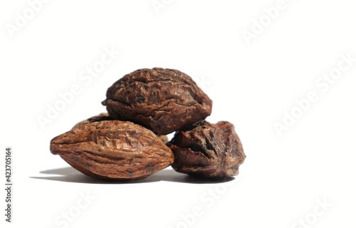 Closeup of Dry Terminalia Chebula or Haritaki Fruit Isolated on White Background with Copy Space, Also Known as Chebulic Myrobalan or Harad photo