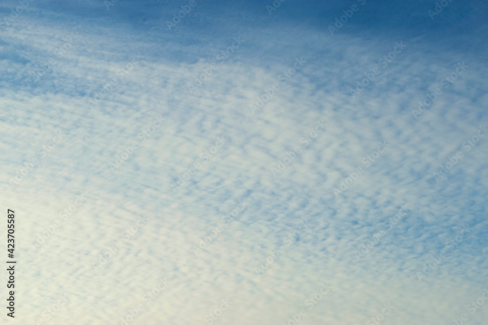 Sunset sky background. Picturesque colorful clouds lit by evening soft sunlight. Vast sky landscape scene - colorful sky