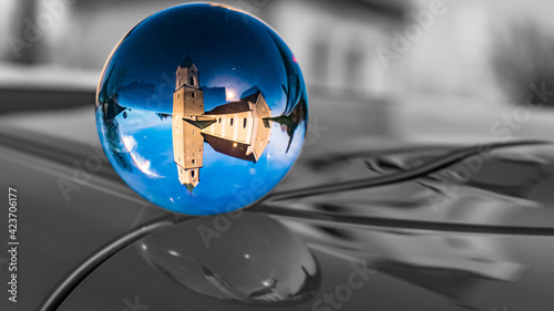 Crystal ball landscape shot with black and white background outside the sphere and a church at Aholfing, Bavaria, Germany © Martin Erdniss