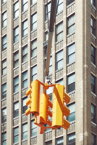 Traffic lights in New York City with high rise building in background, color toning applied, USA.